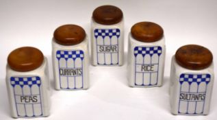 Group of five kitchen containers with wooden tops and blue and white chequered design to front,