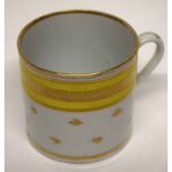 Coalport style coffee can with a yellow and gilt design, height 6cm high