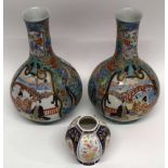 Two Japanese porcelain baluster vases, decorated with panels of Japanese figures, the green ground