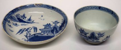 Lowestoft porcelain tea bowl and saucer, circa 1780, with a blue and white design of pagodas, the