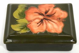 Moorcroft box and cover, the green ground with floral design of hibiscus, 12cm long