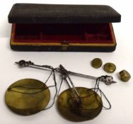 Box containing series of very small brass weights and weighing machine