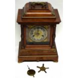 Large mantel clock in wooden case with Roman numerals and gilt spandrels