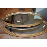 PAIR OF GILT FRAMED OVAL MIRRORS, EACH LENGTH APPROX 77CM