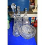 CUT GLASS WARES INCLUDING FOUR DECANTERS AND STOPPERS, AND FRUIT BOWLS