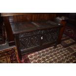 Oak small coffer^ plain two panelled top over carved two panelled front on plain stile feet^ 18th