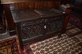 Oak small coffer^ plain two panelled top over carved two panelled front on plain stile feet^ 18th