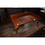 Vintage mahogany bed table^ central adjustable reading slope and gallery surround on short moulded