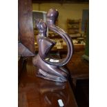 UNUSUAL RESIN STATUETTE OF AN EMBRACING COUPLE, 28CM HIGH