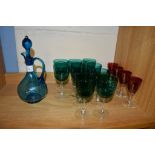 GREEN GLASS CARAFE AND COVER WITH TEN GREEN COLOURED WINE GLASSES AND FOUR RUBY COLOURED GLASSES