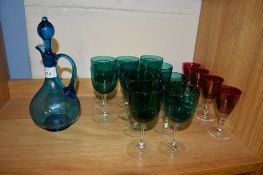 GREEN GLASS CARAFE AND COVER WITH TEN GREEN COLOURED WINE GLASSES AND FOUR RUBY COLOURED GLASSES