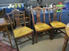 Set of three Chippendale style oak dining chairs^ all with rush seats