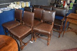 Composite set of leather backed and seated oak framed dining chairs^ comprising two carvers and