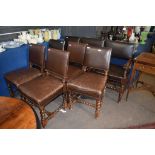 Composite set of leather backed and seated oak framed dining chairs^ comprising two carvers and