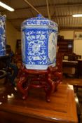 LARGE ORIENTAL OCTAGONAL JAR AND COVER WITH BLUE AND WHITE DESIGN ON WOODEN STAND