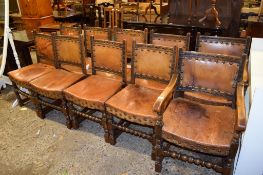SET OF TEN OAK LEATHER BACKED AND SEATED MONASTIC STYLE DINING CHAIRS COMPRISES TWO CARVERS AND