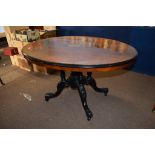 Victorian walnut loo table^ with inlaid central panel^ boxwood stringing and ebonised rim^ raised on