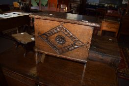 Oak sewing or work box of rectangular form^ lifting lid and carved front on trestle supports in