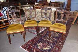 Set of four late 19th century mahogany dining chairs^ pierced vase shaped splat backs and mustard