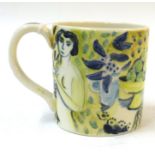 •AR Tessa Newcomb (born 1955), hand painted mug with figures and fruit, initialled and dated 2001 to