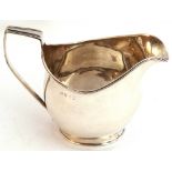 George III helmet shaped cream jug of bellied shape, with reeded square top handle and reeded rim,