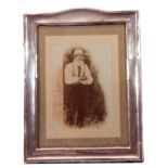 George V silver mounted photograph frame of curved top rectangular form having refurbished wooden