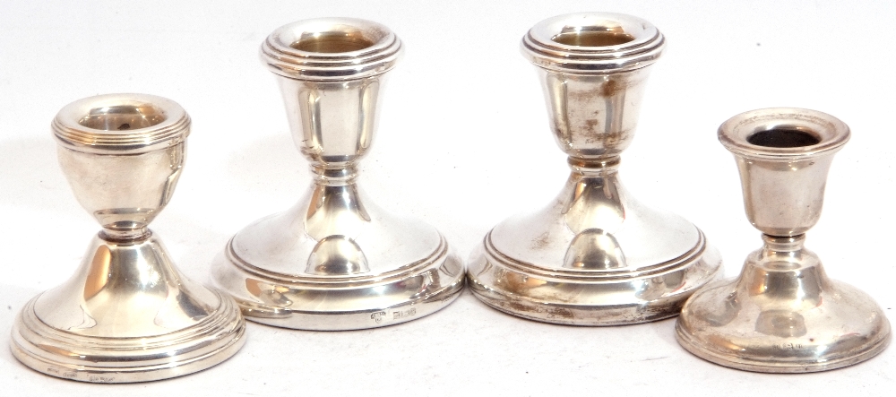 Group: pair of Elizabeth II silver encased dressing table candlesticks on circular loaded bases, 7cm
