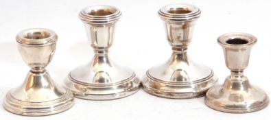 Group: pair of Elizabeth II silver encased dressing table candlesticks on circular loaded bases, 7cm