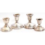 Group: pair of Elizabeth II silver encased dressing table candlesticks on circular loaded bases, 7cm