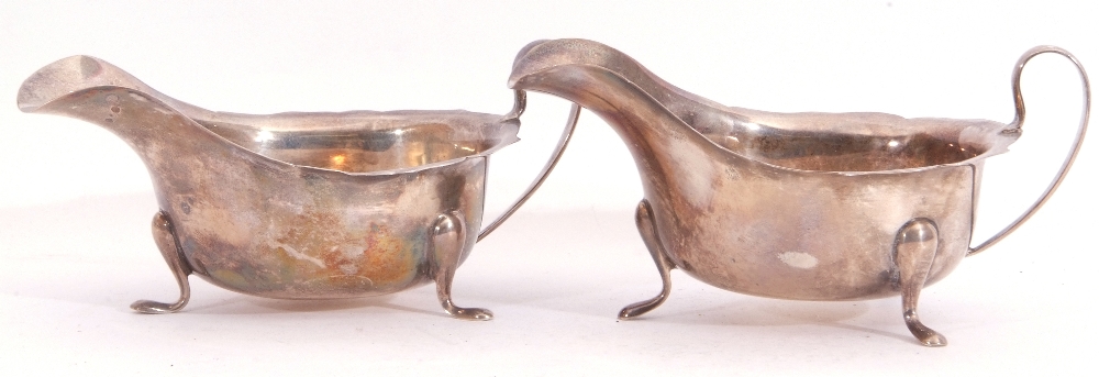 Pair of George VI silver sauce boats each with card cut rims and scroll handles standing on three - Image 3 of 3