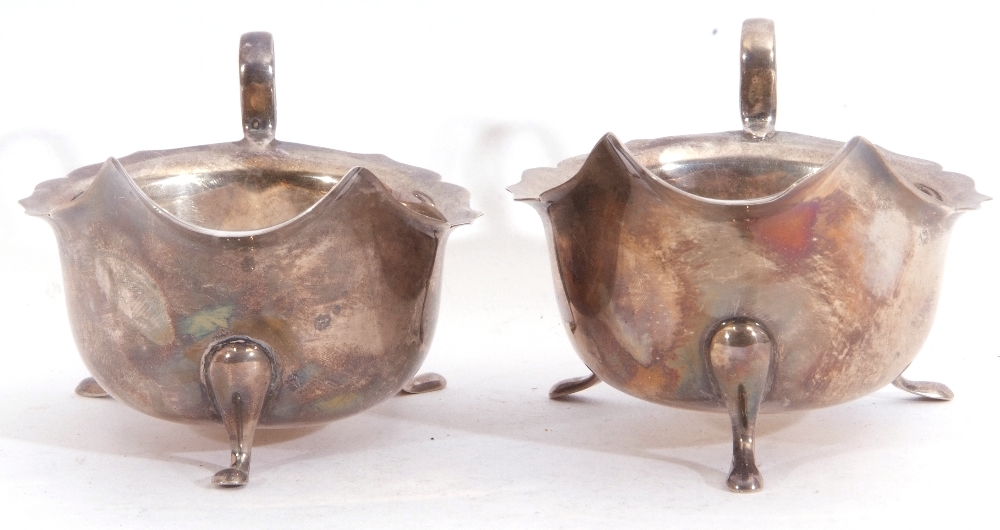 Pair of George VI silver sauce boats each with card cut rims and scroll handles standing on three - Image 2 of 3