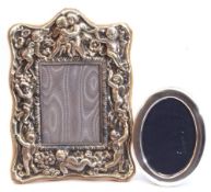 Mixed Lot: an ornate EPNS photograph frame, heavily embossed with cherubs and flowers, easel back,