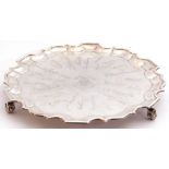 George V presentation silver salver, a round body with a Chippendale style border, standing on three