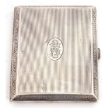 Continental white metal cigarette case of rectangular hinged form, engine turned with linear