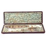 Cased silver plated fish servers with pistol shaped porcelain handles, with hand painted sprays of