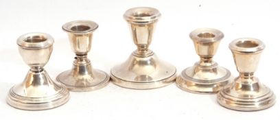 Group of five small 20th century hallmarked silver encased dressing table candlesticks of circular