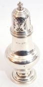 George V silver caster of plain baluster form with pull off cover, pierced with scroll work and