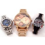 Three cased late 20th/early 21st century designer type quartz movement wrist watches including an