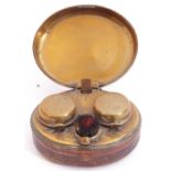 Victorian leather encased and metal framed travelling double inkwell, the hinged lid opening to