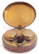 Victorian leather encased and metal framed travelling double inkwell, the hinged lid opening to