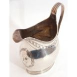 George III helmet cream jug with reeded rim and scroll handle, engraved garland and monogrammed