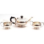 George VI silver three piece tea service comprising tea pot with hinged lid, ebonised finial and