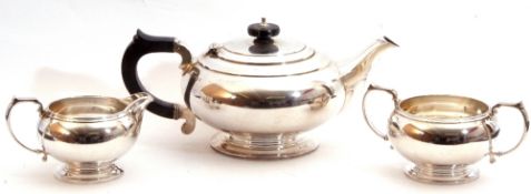 George VI silver three piece tea service comprising tea pot with hinged lid, ebonised finial and