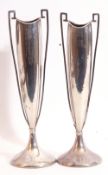 Pair of George V silver table flower vases having tall elongated shaped bodies with square cross