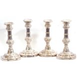 Set of four Regency period Sheffield plated candlesticks having shaped square loaded bases,
