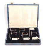 Unusual cased set of six silver plated sandwich flags with slot-in sandwich names