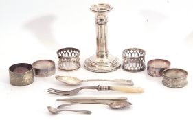 Mixed Lot: single silver dwarf candlestick, Birmingham 1901 (loaded), five silver serviette rings,