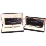 Two modern cased Aurora fountain pens, the first with black lacquered case and gilt fittings, the