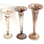 Mixed Lot: three silver trumpet vases, two tapering cylindrical designs and a panelled example,