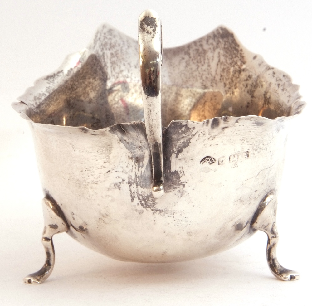 George VI silver sauce boat with shaped rim and capped flying scroll handle, on three cast hoof - Image 2 of 3